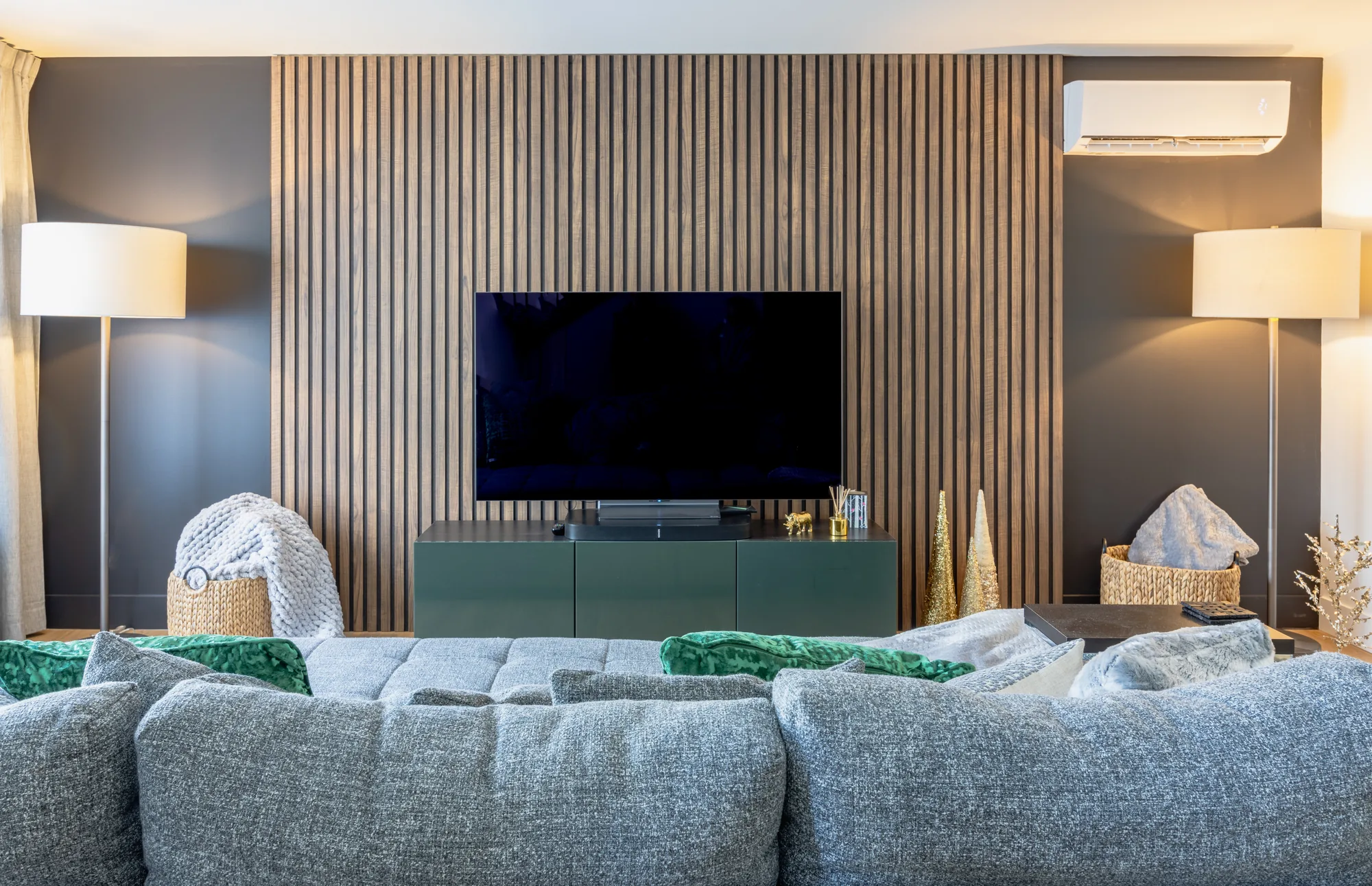 A Halifax living space where existing seating is paired with a new slatted-wood feature wall, styled by MAD Design Interiors